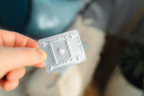 Fototapeta  - Medicine for emergency contraception in a female hand. Emergency contraceptive pill.