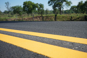 Wall Mural - Blurred image of yellow traffic marking work on paved road