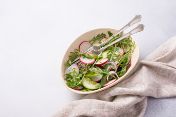 Wall Mural - Healthy vegetarian salad with fresh radish, cucumber, onion and mix of green leaves