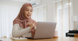 © ChayTee - Asia arab people young woman wear hijab headscarf plan study MBA college class note idea data in sale report remote work at home on laptop. Happy advisor lifestyle smile cowork smart workforce job.