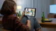 © ChayTee - Young happy attractive asia female enjoy relax night party event online celebration festive with friends at home sofa pr table clinking beer with glass and bottle drinking via online videocall.