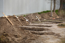 Empty Graves Of The Killed By The Russian Army Civilans And Buried Afterwards By Their Neighbors In The Home Yard, After Exhumation Of Their Bodies 