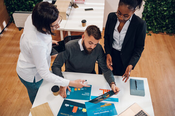 Wall Mural - Multicultural team working together in office and having a meeting