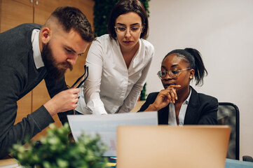 Wall Mural - Multicultural team working together in office and having a meeting