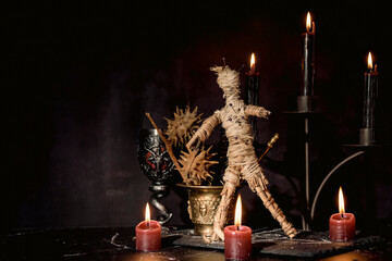 Poster - Voodoo doll, black candles, pentagram and old books on witch table. Occult, esoteric, divination and wicca concept. Mystic, voodoo and vintage background.