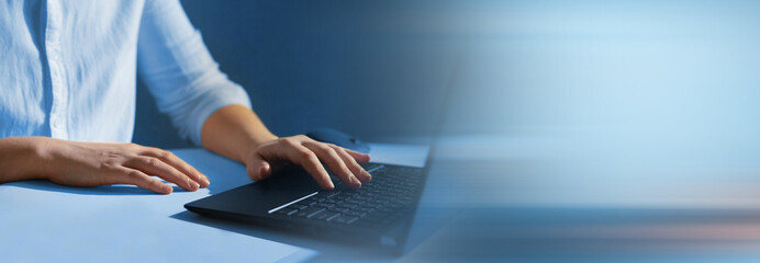 Business person working on laptop. Panoramic business banner with copy space.
