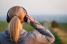 Woman With Headphones Getting Ready For Running On Road. Jogging And Fitness Activity Outdoors