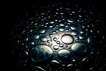 Wall Mural - Abstract dark shiny background with droplets. Droplets background with a dim spotlight.