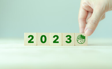 Wall Mural - 2023; Green business, enviromental sustainability. Carbon offset and neutrality strategies.  2023 written on wooden cubes and green community. Goals,plan,opportunity, new green business and social.