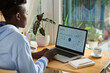 © DragonImages - Young woman analyzing visitors activity chart on laptop screen when working in home office