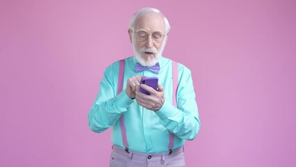 Wall Mural - Aged man use smart device texting isolated pastel color background