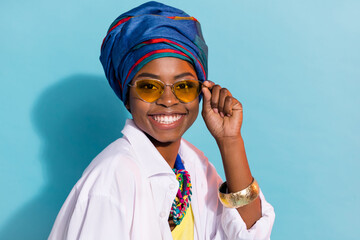 Portrait of gorgeous lady masai tribe look smiling wear national kenya outfit specs isolated blue color background