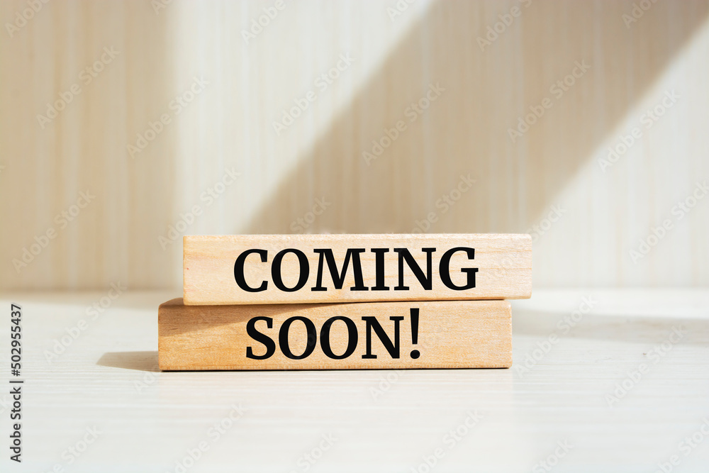 Soon Block Coming soon text concept written on wooden blocks lying on a table ...