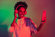 Portrait of attractive cheerful girl listening hit playlist pop single isolated over bright multicolor light gradient color background