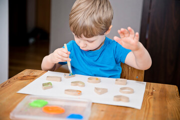 Child learn geometric shapes. Fine motor skills. Preschool or special needs tasks. Early education of children. Montessori methodology.