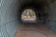 wet bike trail and corrugated metal underpass in Fort Collins, Colorado, early spring scenery, recreation and commuting concept