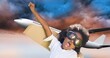 © vectorfusionart - African american boy with cardboard wings and goggles flying and airplane flying in cloudy sky