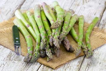 Wall Mural - fresh green asparagus on wooden background