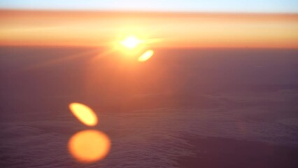 Wall Mural - beautiful sunset aerial view. orange cloudy sky, horizon line, bright gold sun circle rising over ho
