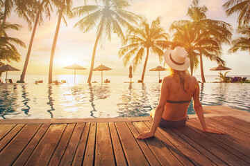 travel, woman in luxury beach hotel at sunset, vacation trip, tourism