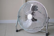 aluminum Electric retro style fan in a room on a wooden floor