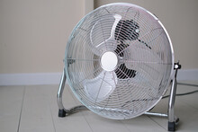 Aluminum Electric Retro Style Fan In A Room On A Wooden Floor