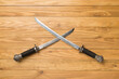 Cossack saber on wooden background, top view