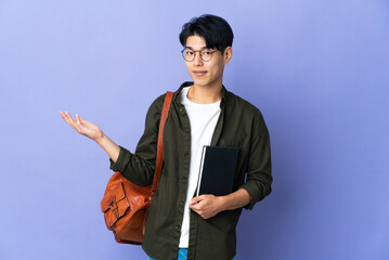 Young student woman isolated on purple background extending hands to the side for inviting to come