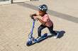© WavebreakMediaMicro - High angle view of african american boy riding push scooter on promenade during sunny day
