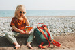 © EVERST - Child girl with lunchbox eating vegetables outdoor travel vacation healthy lifestyle vegan food picnic on beach hungry kid with lunch box snacks and backpack