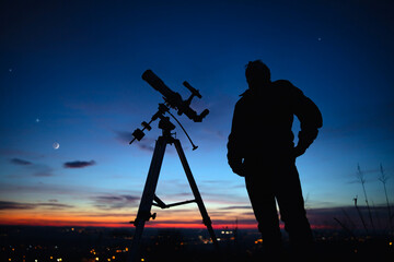 Wall Mural - silhouette of a man, telescope and countryside under the starry