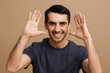 © SHOTPRIME STUDIO - handsome man in gray t-shirts gesture hands smile emotions beige background