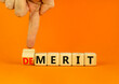 © Dzmitry - Demerit or merit symbol. Businessman turns wooden cubes and changes the concept word Demerit to Merit. Beautiful orange table orange background. Business and demerit or merit concept. Copy space.