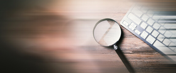 Internet search concept, magnifier and computer keyboard