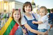 © MNStudio - Two big sisters and a cute toddler boy holding tricolor Lithuanian flag on Lithuanian Statehood Day, Lithuania