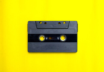 Wall Mural - Old compact cassette tape on yellow background