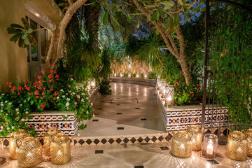 Wall Mural - copper lanterns with candles entrance pathwout of focus with grain