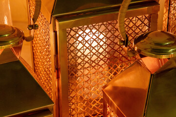 copper lanterns with candles at night close up with grain and ou