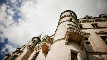 Wall Mural - Low angle shot of the Dunrobin Castle & Gardens, Stately home in Scotland with cloudy sky