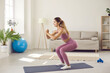 © Studio Romantic - Toned young Caucasian girl in sportswear train exercise on mat at home. Sporty fit millennial woman have workout fitness pilates session indoors, follow healthy lifestyle. Sport, activity concept.