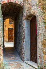 Wall Mural - Dark alley to a street in an Italian village