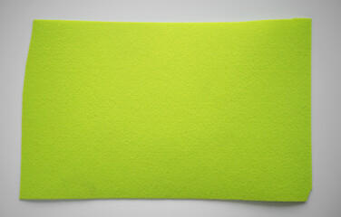 Wall Mural - A piece of felt fabric of light green color. Pure green fabric on a white background.