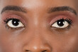 © Sondem - Close up, profle photo of a dark skin female eye, iris, pupil, eye lashes, eye lids.
