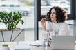 © LIGHTFIELD STUDIOS - Arabian businesswoman holding pen near laptop and clipboard in office.