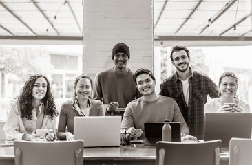 Wall Mural - Smiling multiethnic coworkers looking at camera making team picture in modern office together - Happy diverse work group or department laugh posing for photo at workplace - Show unity and cooperation