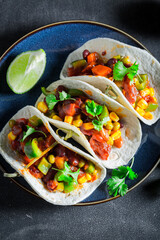 Wall Mural - Vegetarian and healthy tacos made of tomatoes, avocado and hebrs.