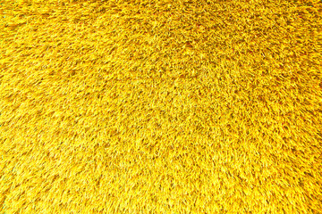 Background of yellow texture of artificial grass cover, seamless background.