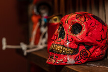 Closeup Shot Of A Skull Red Sculpture With Brown Teeth And Black Patterns