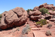 Pathway With Steps Between Large Red Rocks In Canyonlands National Park, Utah, USA