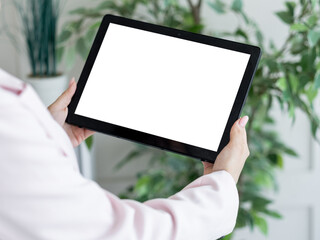 Canvas Print - Virtual life. Digital mockup. Computer connection. Unrecognizable woman holding tablet computer with blank screen in light room interior.